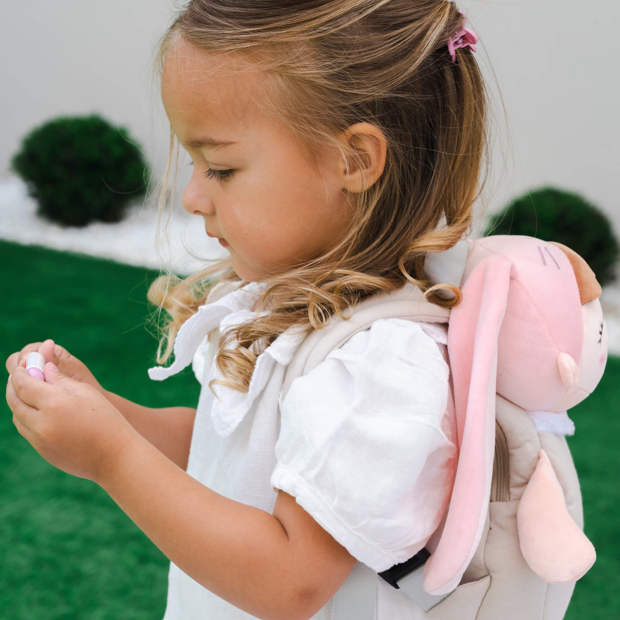 Child carrying her Dreambaby toddler super soft rabbit backpack